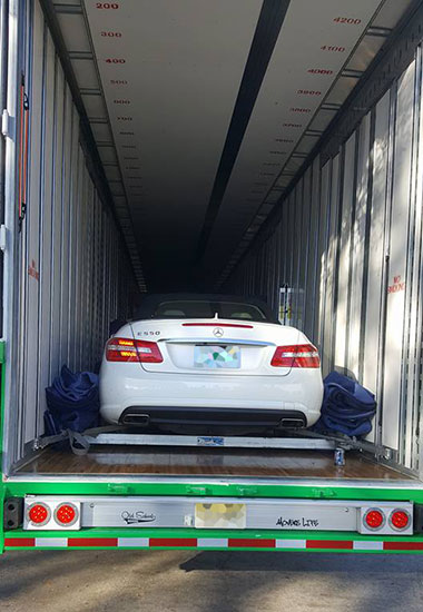 mercedes in moving company trailer