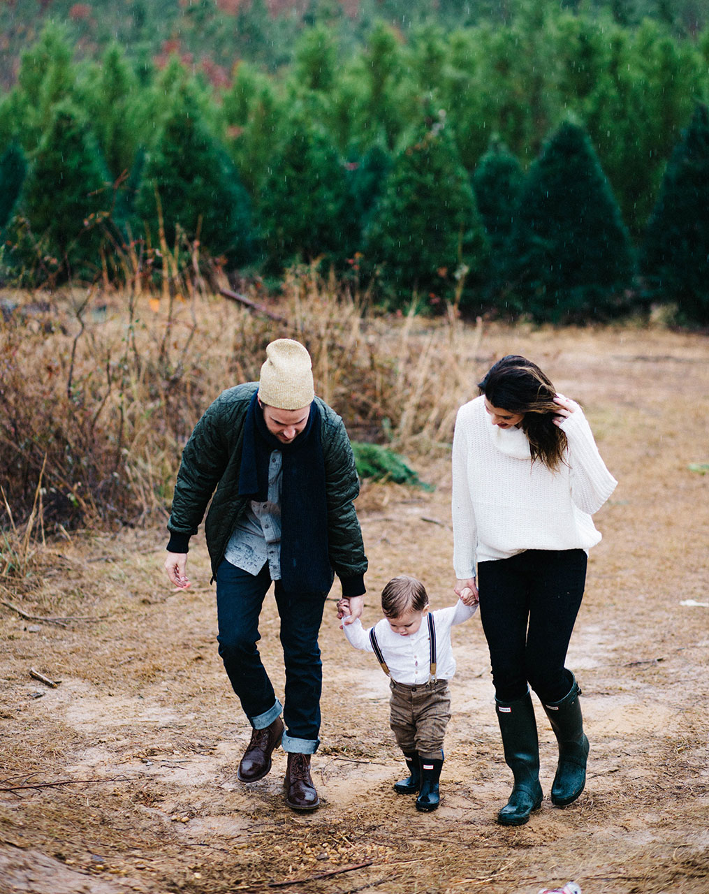 young family in woods walking