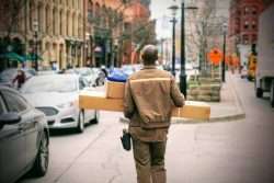 worker walking with boxes