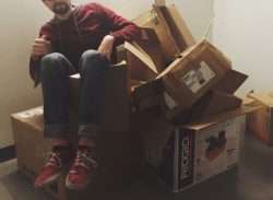 person sitting on boxes