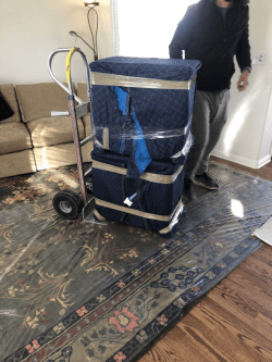 Padded furniture loaded onto a dolly