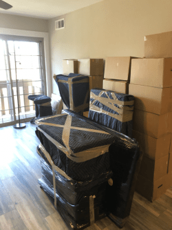 moving boxes and other packed items in large room