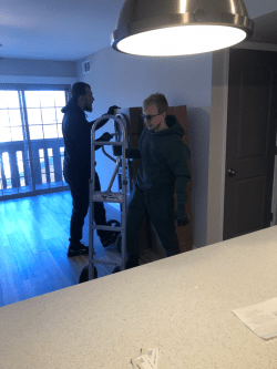 Movers using a dolly to move heavy furniture