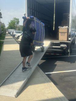 man rolling furniture up loading ramp
