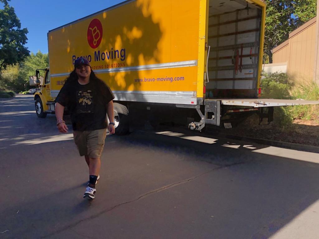 Greg Gurrola in front of a Bravo moving truck