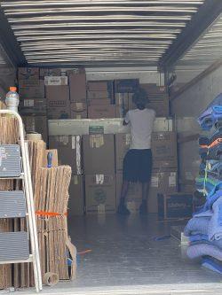 man unloading boxes in moving truck