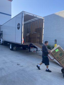 Safeway Moving Inc mover taking boxes off a moving truck