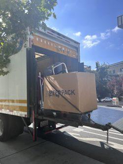 Moving box being unloaded from a truck