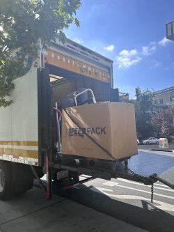 Moving box being unloaded from a truck