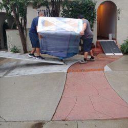 Berger Allied employees carrying large furniture