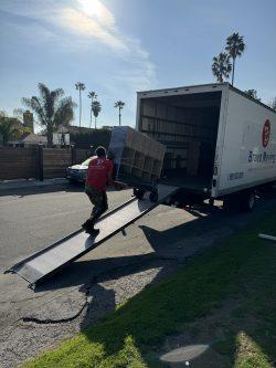 Man loading a Bravo Moving truck