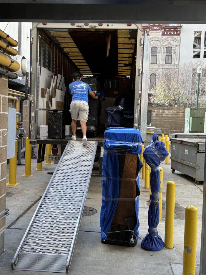 BLVD Moving crew member loading Dana's items into the moving truck